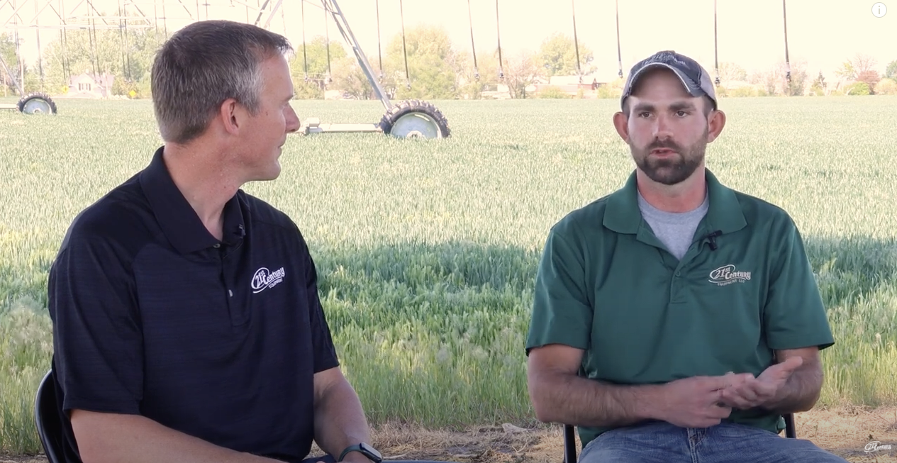 Two 21st Century Equipment employees having a conversation on the FarmCast.